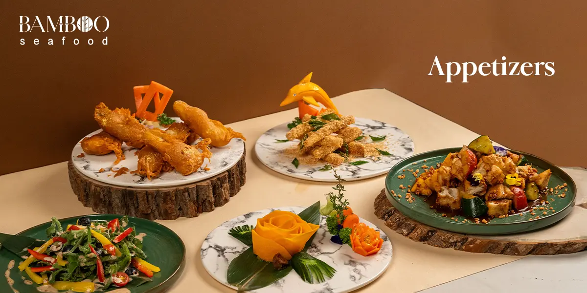 bamboo seafood menu page which includes assorted appetizers including fried items, fresh vegetables, and dipping sauces on a wooden serving board at